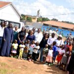 Some of the inter-faith youth take a photo with the community members after raising awareness on disease control in Kampala City.